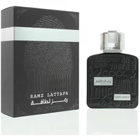 Lattafa Ramz Silver Eau De Parfum 100ml, black bottle with embossed design and silver cap, next to matching box.