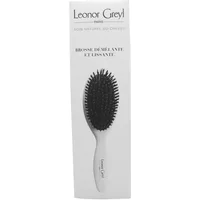 White Leonor Greyl boar bristle detangling brush with black bristles and ergonomic handle in branded packaging.