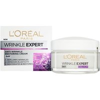 L'Oreal Wrinkle Expert Day Cream 55+ in white jar with silver lid, next to matching box with purple accents.