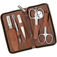 Brown leather manicure kit with scissors, tweezers, nail file, and cuticle pusher in a zippered case.