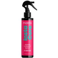Black spray bottle with pink label, teal text "InstaCure," and black nozzle, Matrix Total Results leave-in treatment.