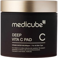 Black jar with gold lid labeled "Medicube Deep Vita C Pad" for brightening tired-stressed skin.