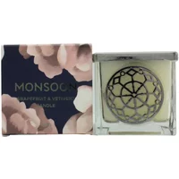 Monsoon Grapefruit & Vetiver candle in clear glass jar with decorative metal lid, floral box packaging.