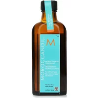 Amber glass bottle with black cap, turquoise label, and orange "M" logo, containing Moroccanoil Treatment Original 100ml.
