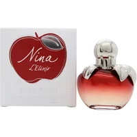 Red apple-shaped Nina Ricci Nina E'lixir perfume bottle with silver cap, next to branded box.