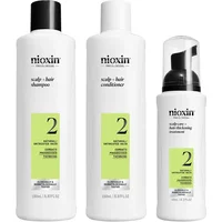 Nioxin Pro Clinical System 2 kit with white shampoo, conditioner, and foam bottles, green labels, and black caps.