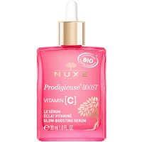NUXE Prodigieuse Boost serum in a pink glass bottle with a gold dropper cap, featuring white text and floral design.