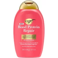 Pink OGX Bond Protein Repair Shampoo bottle with gold cap, 385ml, featuring gold label and black text.