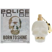 White skull-shaped Police perfume bottle with gold accents, next to matching box labeled "Born To Shine" 75ml.