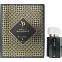 Black Ramon Monegal Soul Of Oud perfume bottle with white cap, next to ornate gold-patterned box.