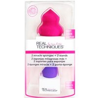 Real Techniques Miracle Sponges, pink and purple, with matching stands in clear packaging.