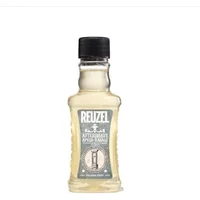 Reuzel Aftershave 100ml in clear ribbed bottle with black cap and gray label featuring vintage design.
