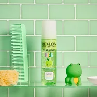 Revlon Equave Kids Apple Shampoo & Conditioning Spray, green bottle with apple graphic, on glass shelf.