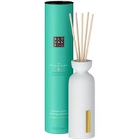 White ceramic bottle with natural sticks and teal cylindrical box, Rituals Karma Mini Fragrance Sticks 70ml.