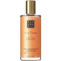 Rituals Karma Shimmering Body Oil 100ml, clear bottle with golden cap, orange shimmering liquid inside.
