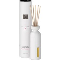 White Rituals Sakura fragrance sticks in ribbed ceramic vase with gold accent, next to matching cylindrical box.