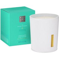 White Rituals scented candle in ribbed holder with gold accent, next to turquoise box labeled "The Ritual of Karma" 290G.