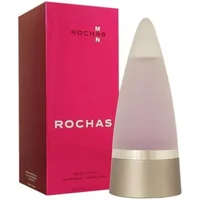 Frosted glass cone-shaped Rochas Man Eau De Toilette bottle with metallic base, next to red packaging box.
