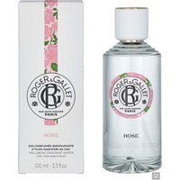 Clear glass bottle of Roger & Gallet Rose Wellbeing Fragrant Water, white cap, floral label, next to matching box.