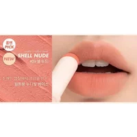 Rom&nd Zero Matte Lipstick 09 SHELL NUDE, soft peach shade, sleek white tube, shown applied on lips.