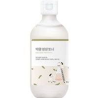 White Round Lab Soybean Nourishing Toner bottle, 300 ml, with green label and minimalist design featuring small illustrations.