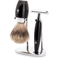 Black and chrome safety razor kit with stand, featuring a shaving brush and razor by Mühle.