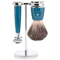 Mühle Rytmo Pur safety razor kit with teal handles, chrome accents, and brush on a sleek silver stand.