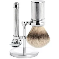 Chrome safety razor kit with textured handle, shaving brush, and stand by Mühle Tradition Pur.