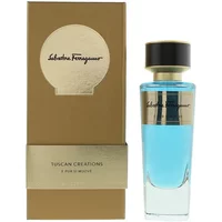 Blue Salvatore Ferragamo perfume bottle with gold cap and label, next to a gold and beige box.