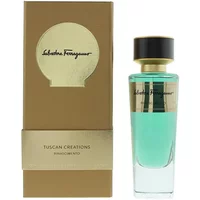 Elegant Salvatore Ferragamo perfume bottle with gold cap and turquoise liquid, next to a brown and gold box.