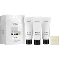 Scottish Fine Soaps Au Lait gift set with white tubes, black caps, and a small square soap bar.