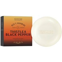 Round white shampoo bar with embossed text, next to orange and black carton labeled "Thistle & Black Pepper."