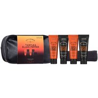 Black travel bag with four orange and black Thistle & Black Pepper toiletries by Scottish Fine Soaps.