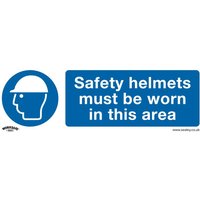 Sealey rigid plastic sign with blue circle, white helmet icon, and text "Safety helmets must be worn in this area"