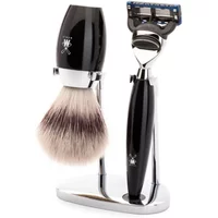 Black and chrome Mühle Kosmo Fusion shaving kit with brush and razor on a sleek stand.