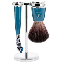 Teal and chrome shaving kit with brush and razor on a sleek silver stand.