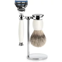 Shaving kit with white-handled razor, matching brush, and chrome stand, featuring Mühle Sophist Fusion Pur design.