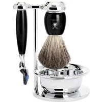 Shaving kit with black-handled razor, brush with silver stand, and chrome bowl by Mühle.