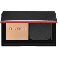Black compact with Shiseido logo, featuring beige powder foundation and black applicator sponge.