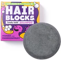 Shower Blocks solid shampoo, round gray bar, with colorful mango and passionfruit packaging.