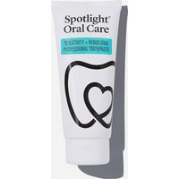 White tube of Spotlight Oral Care Sensitivity + Rebuilding Toothpaste with black tooth icon and teal label.