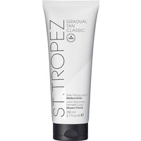 White tube of St. Tropez Gradual Tan Body Lotion, Medium to Dark, 200ml, with black cap and bold black text.