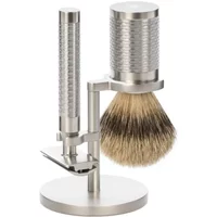 Stainless steel shaving kit with textured handle, brush, and stand by Mühle Rocca Pur.
