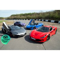 Supercar driving experience featuring red Ferrari, silver Lamborghini, blue McLaren, and purple Aston Martin on a racetrack.