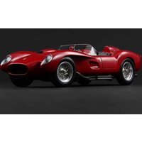 Red Ferrari 250 Testa Rossa with sleek curves, open-top design, and chrome wheels against a dark background.