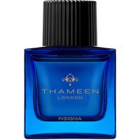 Blue glass bottle of Thameen Insignia Extrait de Parfum with black ribbed cap and gold logo.