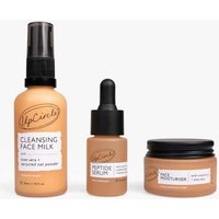 UpCircle Discovery Set with Cleansing Face Milk, Peptide Serum, and Face Moisturizer in amber bottles and jars.