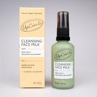 Green UpCircle Cleansing Face Milk bottle with black pump, next to beige box labeled with oat powder details.