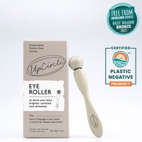 Beige UpCircle Eye Roller with rounded stone tip next to a brown box with black text and eco-friendly certifications.