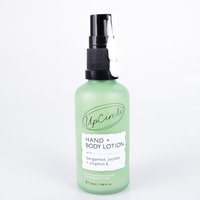Green UpCircle hand and body lotion bottle with black pump, labeled with bergamot water and vitamin E, 50ml size.
